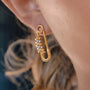 two-tone stainless steel safety-pin earrings worn on ear
