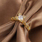 front angle of clear zirconia geometric ring on brown satin
