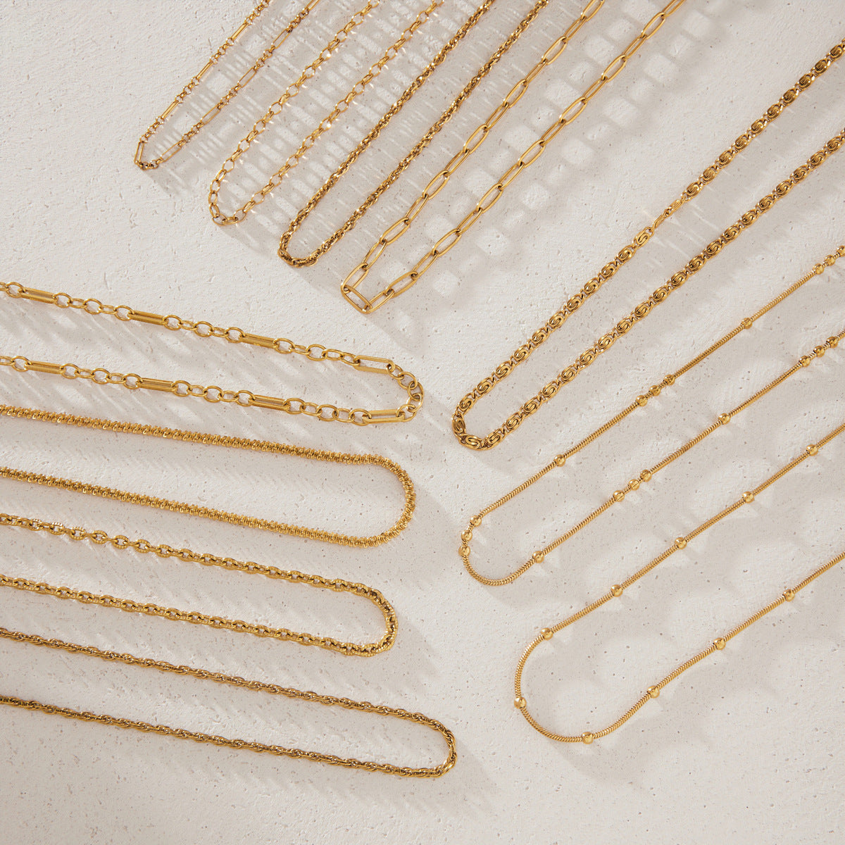 Eleven chain styles arranged in curved parallel rows