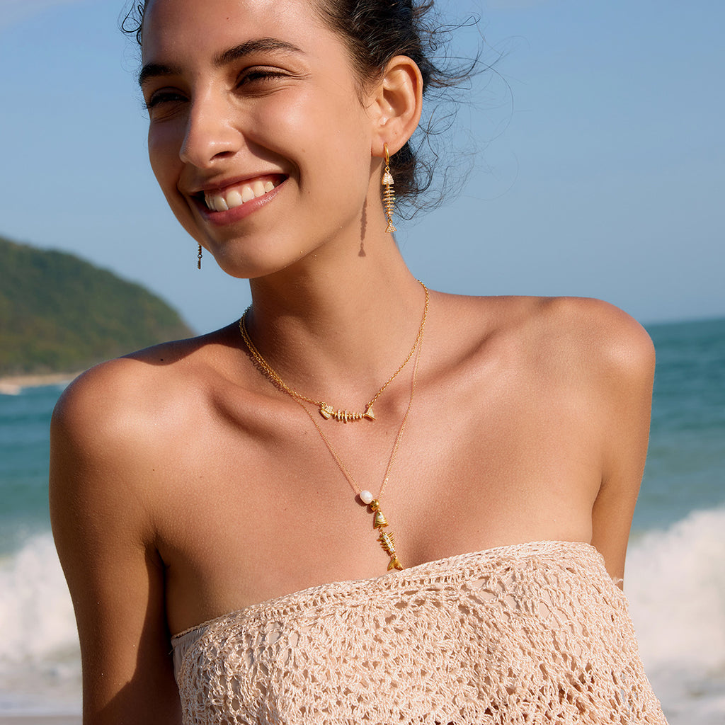 Fish necklace and drop earrings worn together