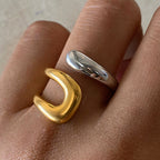 Two-tone sculptural stainless steel open ring worn on a finger