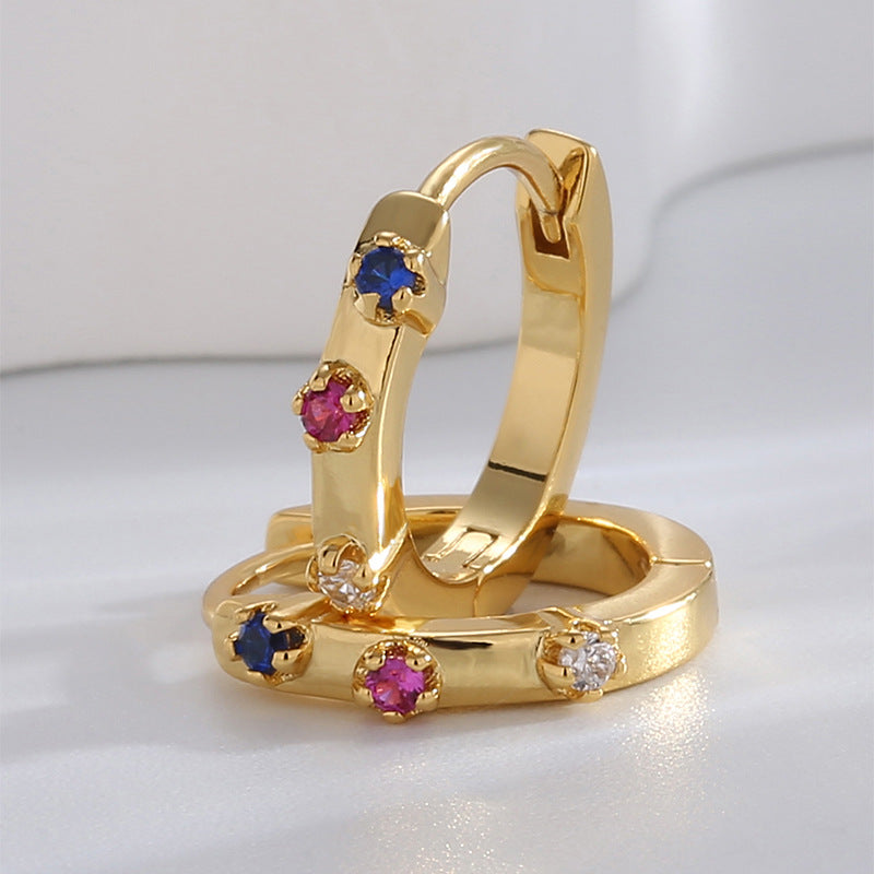 compact huggie hoops with blue pink and clear stones close-up