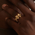 Close-up of the gold plated flower ring on a finger