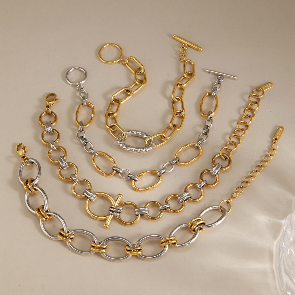 Gold-tone and silver-tone bracelet styles on stone