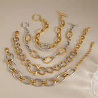 Gold-tone and silver-tone bracelet styles on stone