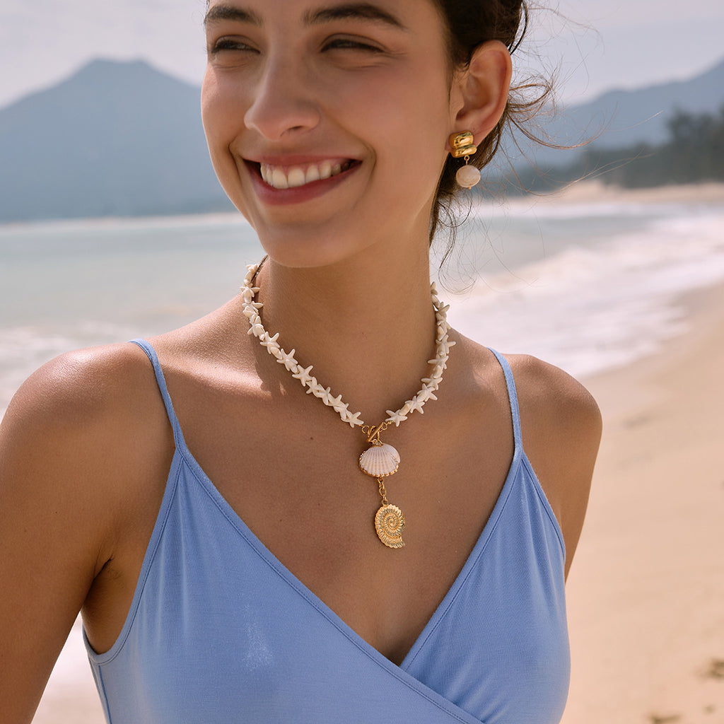 White starfish necklace and bead earrings worn together