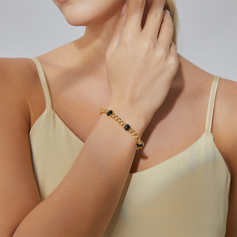 model wearing a gold plated black agate chain bracelet