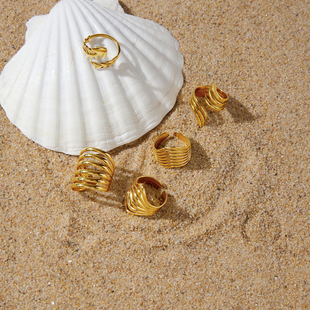 Fish skeleton ring styled on a shell beside other rings