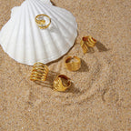 Fish skeleton ring styled on a shell beside other rings