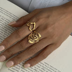 Heart and rose rings styled over a book