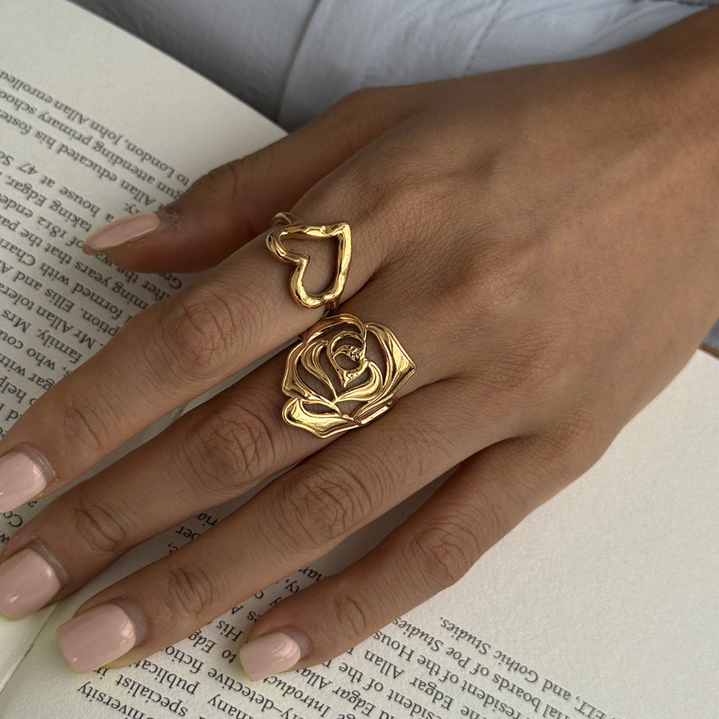 Heart and rose rings styled over a book