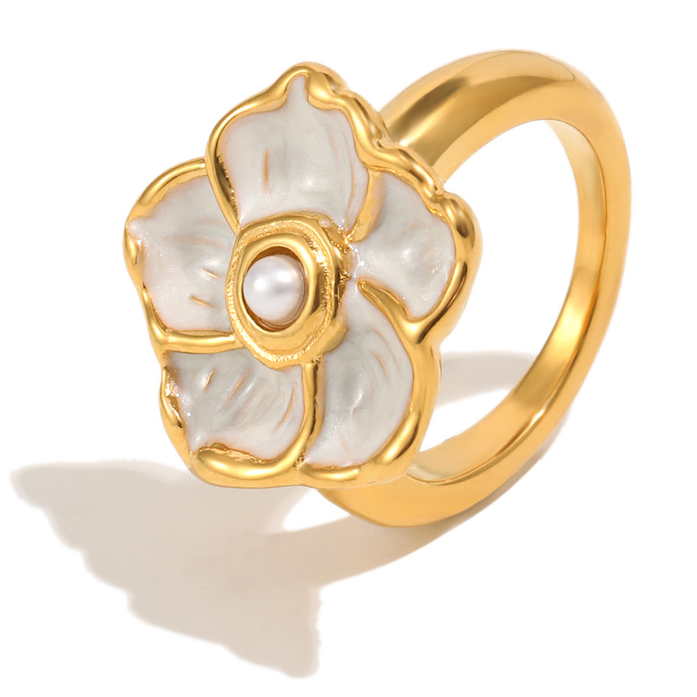 isolated gold plated flower ring with pearl-style center