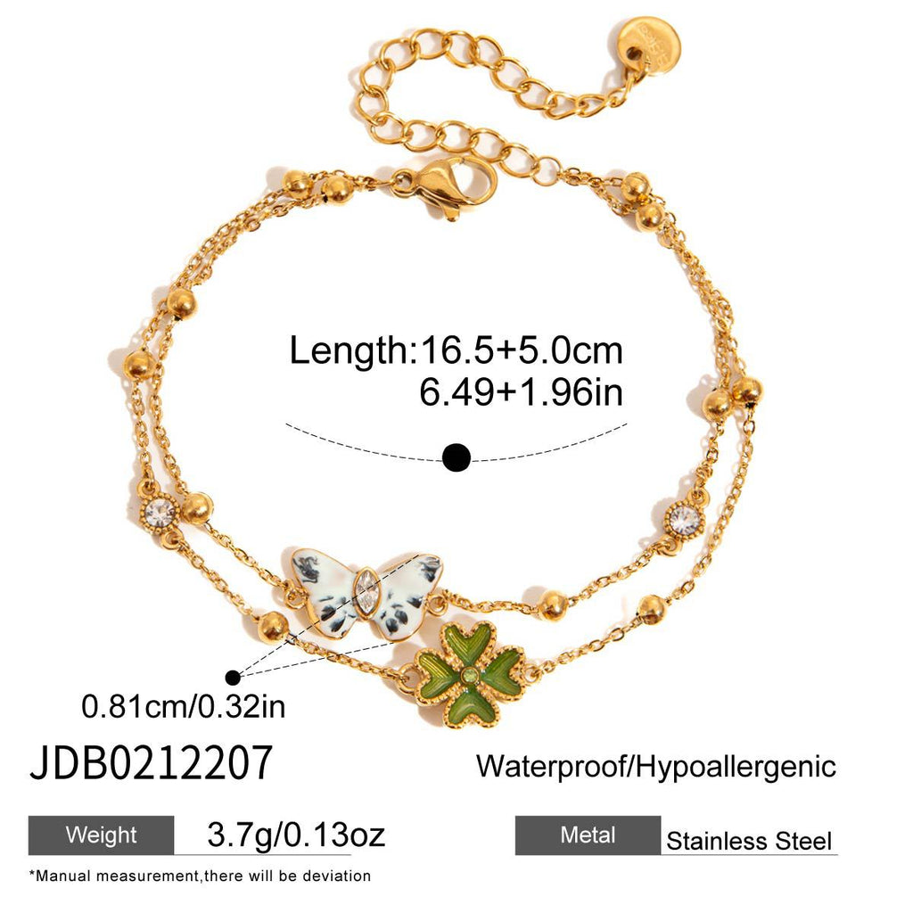 Layered butterfly and green clover charm bracelet with length diagram