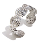 Silver-color spiral disc stainless steel cuff on white