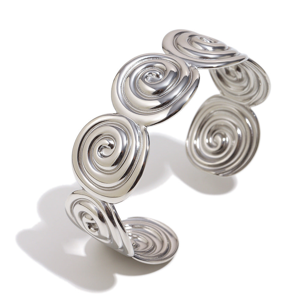 Front view of the silver-color spiral disc cuff
