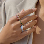 Colored stainless steel rings worn in stacks