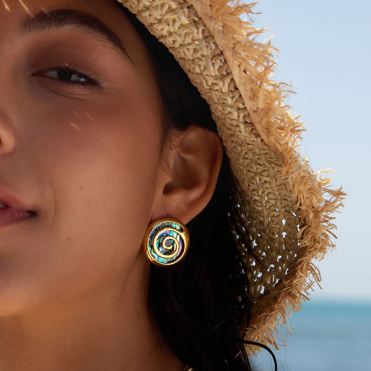 Abalone spiral stud worn close-up