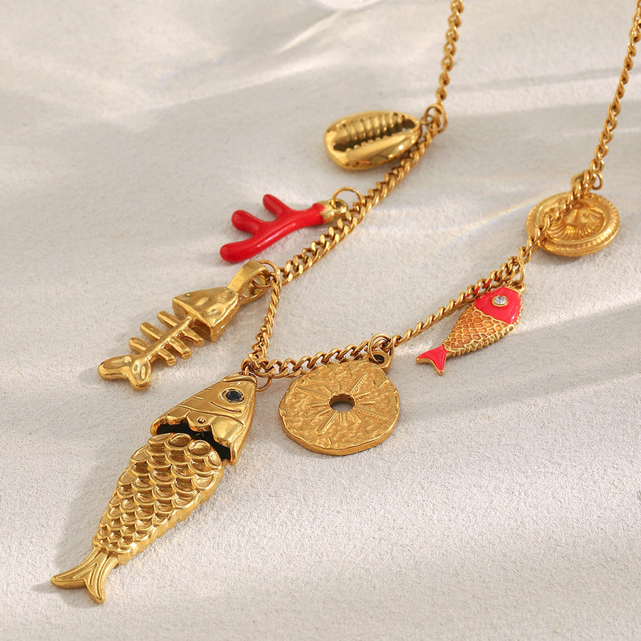 Gold plated stainless steel coastal fish charm necklace, close-up view