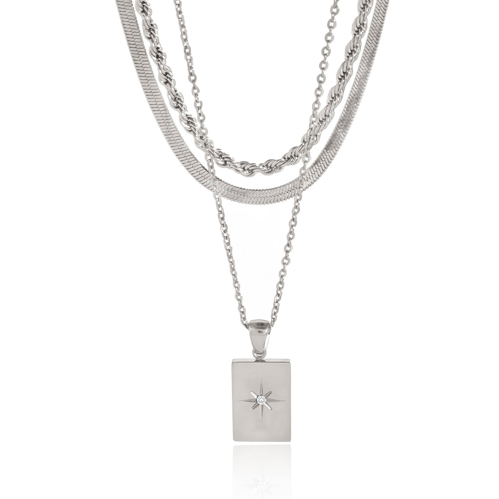 Front view of silver-color three-strand star tag necklace