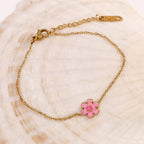 Pink petal bracelet laid on a shell