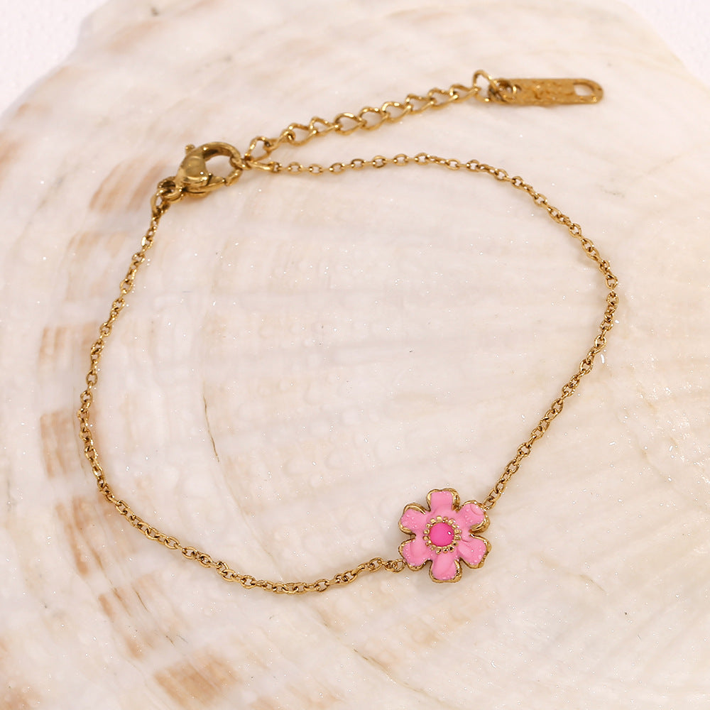 Pink petal bracelet laid on a shell