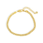 curved display of gold plated brass Cuban bracelet