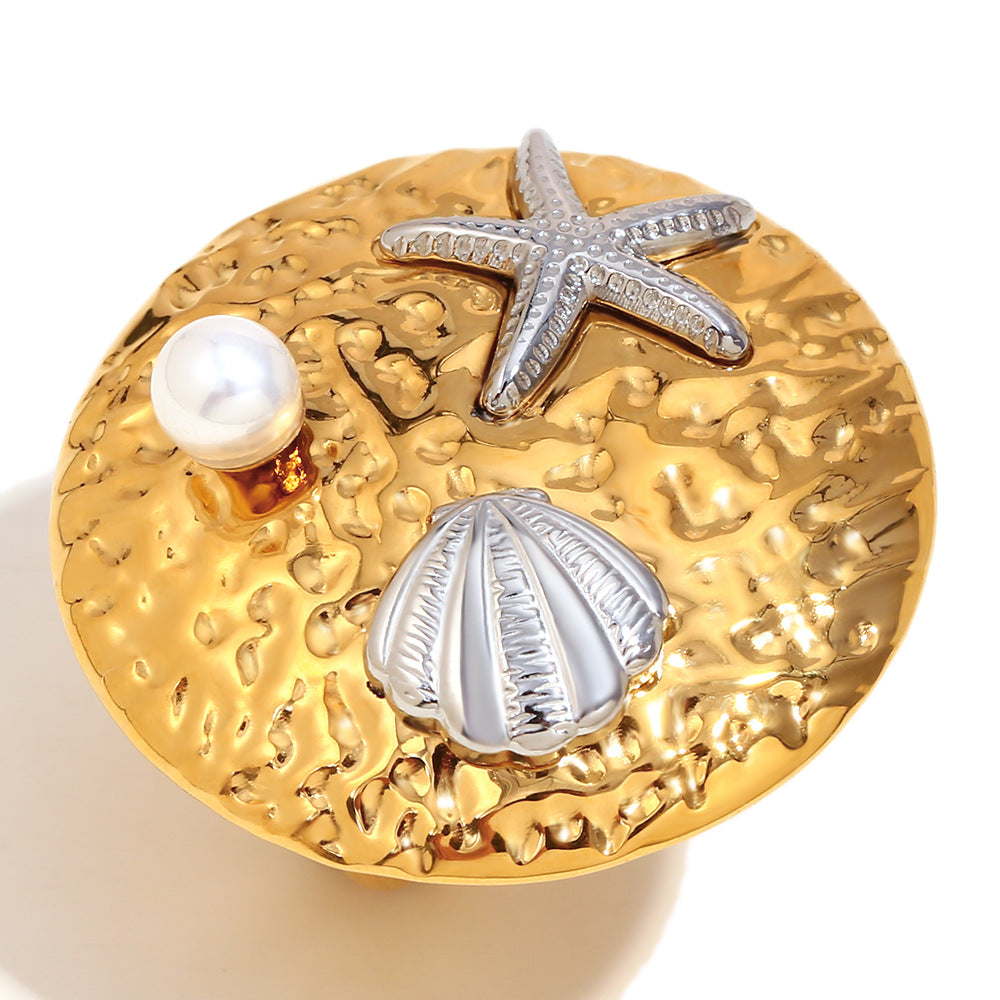 isolated two-tone starfish shell and pearl statement ring