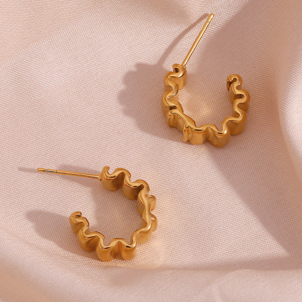 Gold Plated 316L Stainless Steel Pleated Hoop Earrings — pair on pink fabric with scalloped inner edges