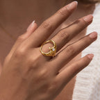 Open crescent-face ring worn on a finger