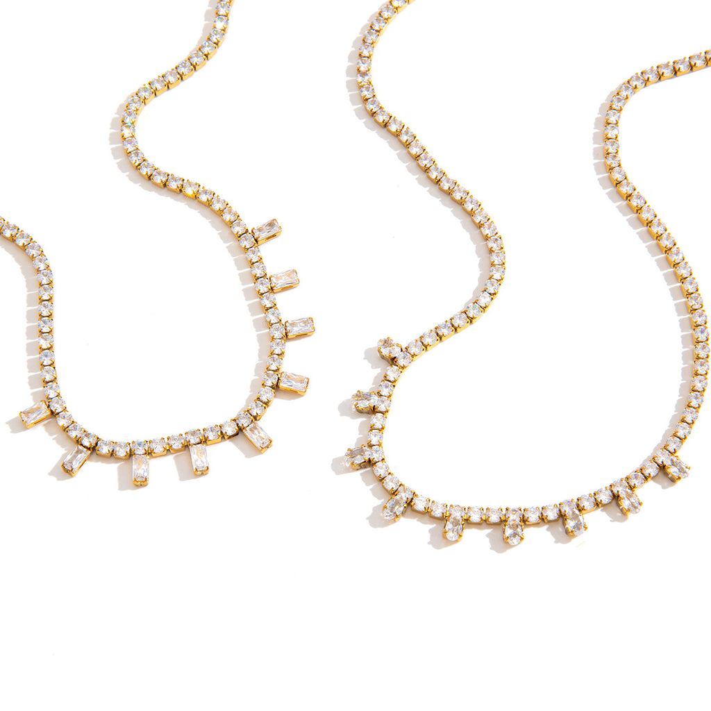 Gold-tone tennis necklaces on white