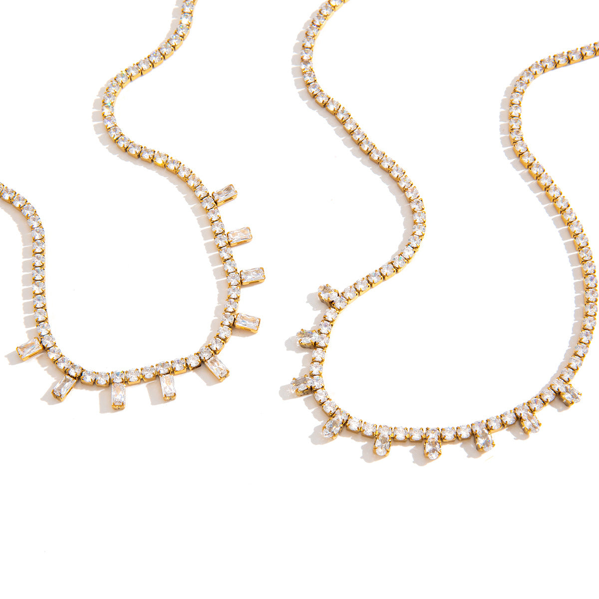 Gold-tone tennis necklaces on white