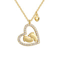 isolated gold plated baby footprint heart pendant necklace