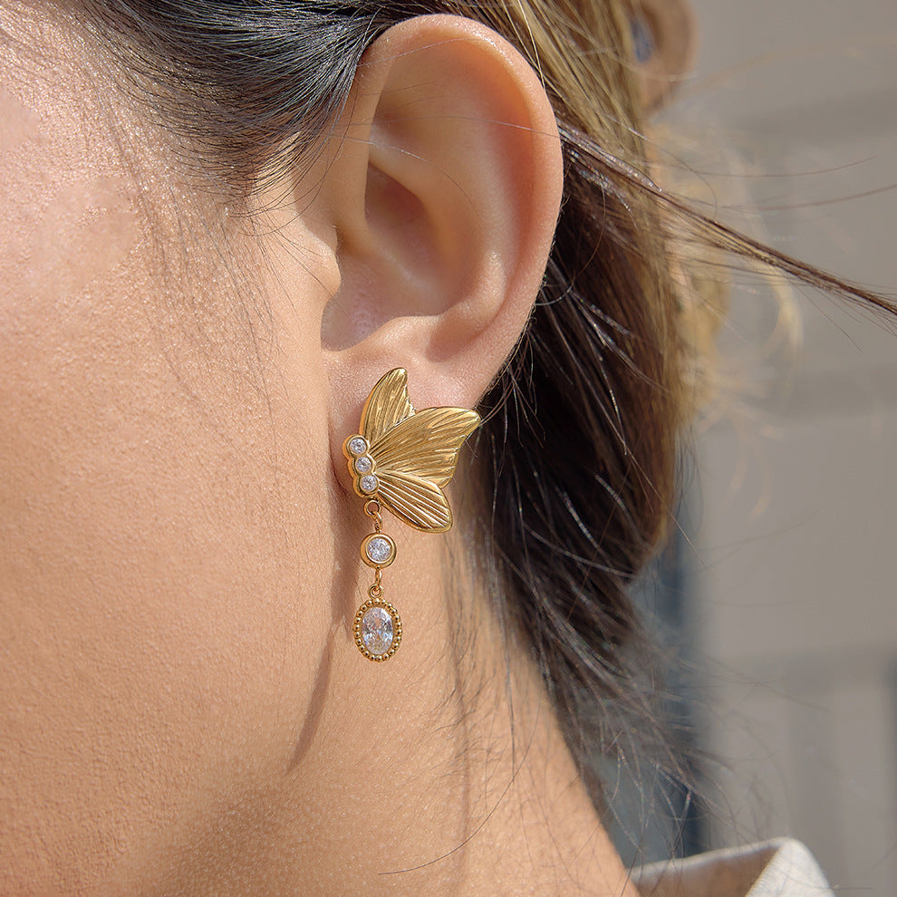 gold plated butterfly clear-stone drop earring worn on ear