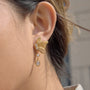 gold plated butterfly clear-stone drop earring worn on ear