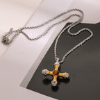 Two-tone rounded cross pendant on a silver-colored rope chain