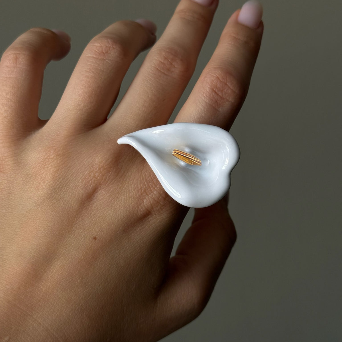 White calla lily statement ring worn on a hand