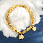 starfish medallion bead bracelet styled on white granules