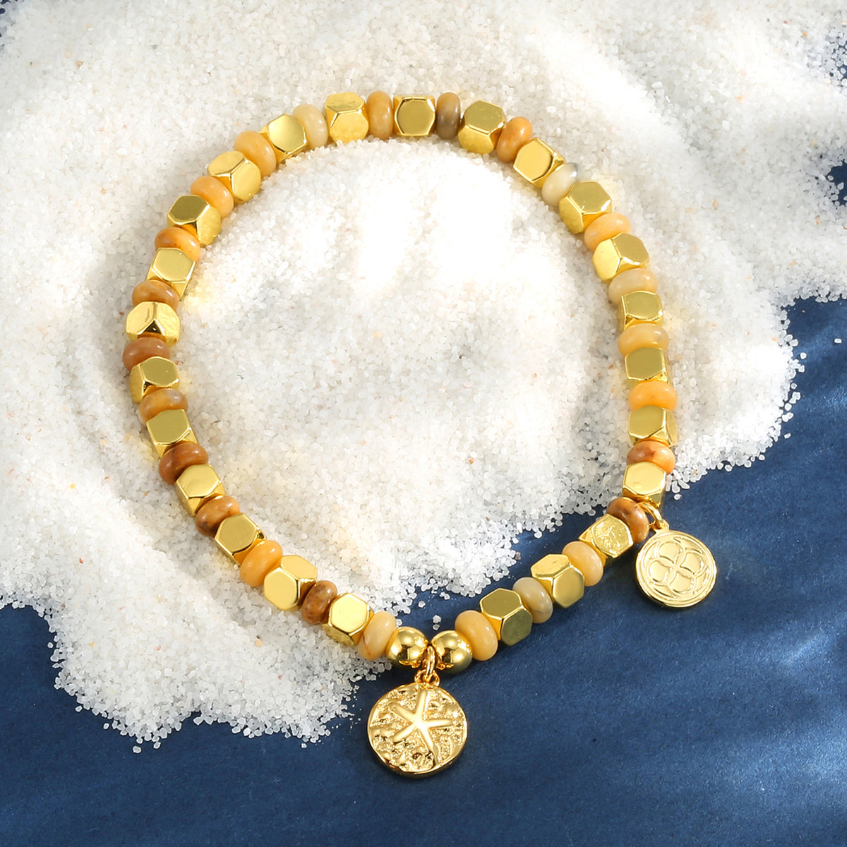 starfish medallion bead bracelet styled on white granules