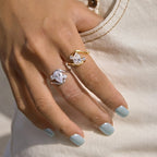 Gold-tone and silver-tone pear-stone rings worn on fingers