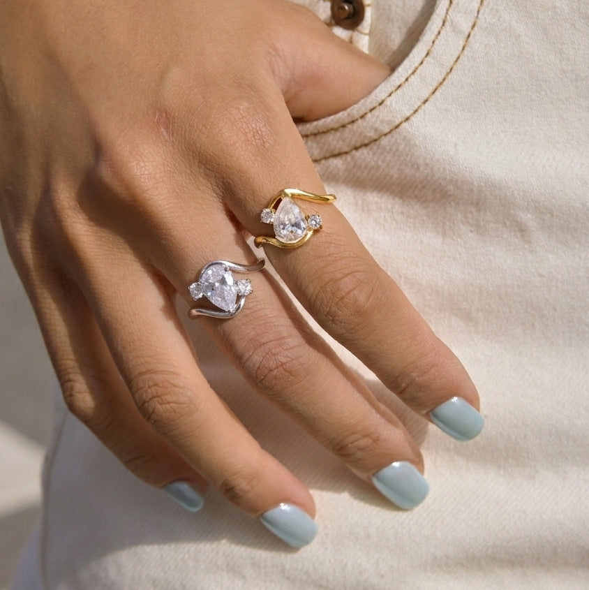 Gold-tone and silver-tone pear-stone rings worn on fingers