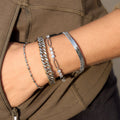two-tone Cuban chain bracelet styled in a silver bracelet stack