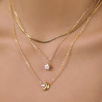 Clear star and gold tone crescent pendants worn together