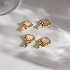 Clear and green rectangular stone hoops arranged together