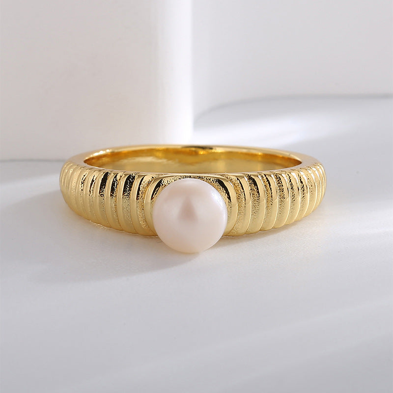 front profile of closely grooved gold plated pearl ring