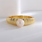 front profile of closely grooved gold plated pearl ring