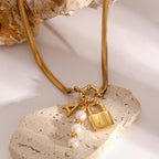 Gold-Tone Stainless Steel Lock Charm Necklace with Pearl-Look Drop — front view