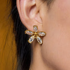 Gold-tone clear stone flower stainless steel stud earrings worn view