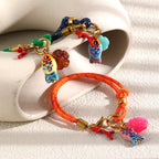 Close-up of fish flower and coral-shaped bracelet charms