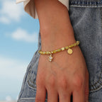 model wearing the sea turtle pale yellow bead bracelet outdoors