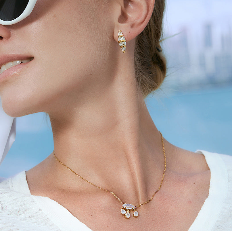 Elongated diamond-shaped stud worn on model
